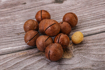 Brown macadamia nut heap over background