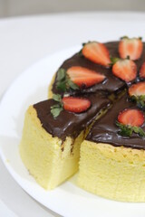 Japanese cheesecake with chocolate and strawberry topping.