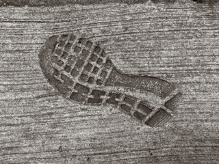 Image of a shoe print. Man shoe print left in concrete cement. Man footprint left in concrete cement. 