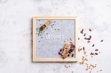 Various dried legumes with felt letter board with the text Legumes top view flat lay