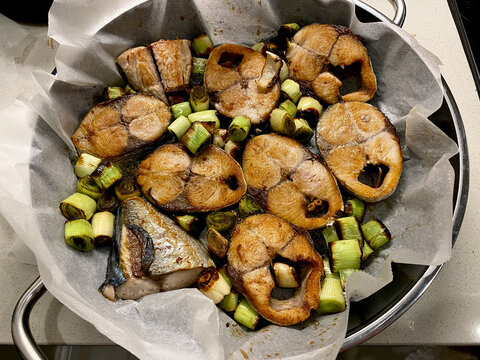 Bonito Fish Pieces with Leek and Vegetables Baked in Oven with Pan / Baking Parchment Paper.