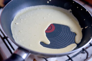 Cooking pancakes. Pancake batter in a frying pan. Close-up.