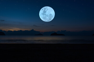 Full moon with silhouette mountain and beach in the night.