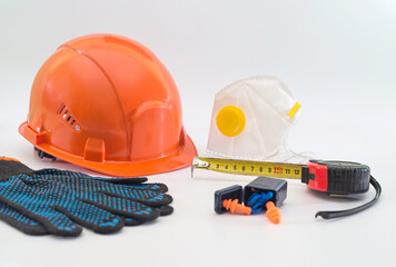 safety equipment with helmet, respirator, ear plugs and gloves isolated on white.