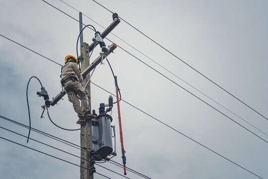 Lineman climb concrete pole and use clamp stick grip all types to connect the single phase transformer to the distribution system.