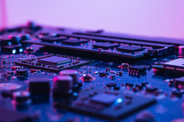 Abstract computer background with electronic device, neon colors toned. Macro photography of...