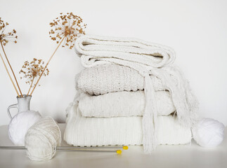 Fototapeta na wymiar white knitted sweaters on a light background