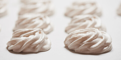 Cooked homemade meringue cookies on baking paper