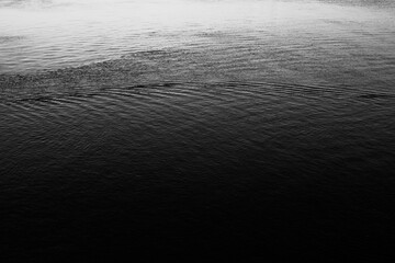 Close-up of water texture, smooth waves of water on the shore, landscape photo of water 