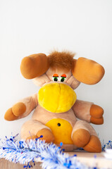 elk toy made by plush with a white tinsel on white background