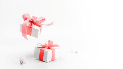 Winter sale. White gifts with red ribbon and New Year balls in xmas decoration on white background for greeting card. Christmas, winter, new year concept.
