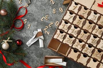 Flat lay composition with wooden advent calendar and Christmas decor on grey background