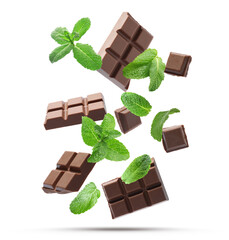 Milk chocolate pieces and mint falling on white background