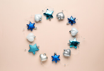 Beautiful festive wreath made of different Christmas balls on beige background, top view