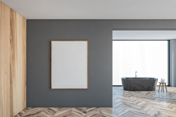 Mockup canvas frame on grey wall in bathroom with grey bathtub and window