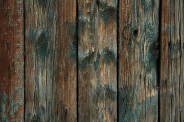 Dark old wooden surface made of separate wooden boards with the remains of paint. Can be used as background with natural texture