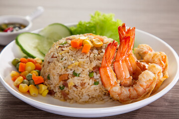 chinese fried rice with barbecue prawn on wooden table