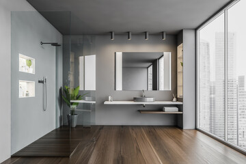 Grey bathroom with shower cabin and sink with mirror near big window