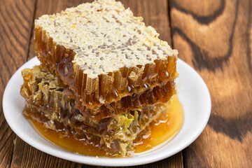 Honey, honey in combs on a wooden background