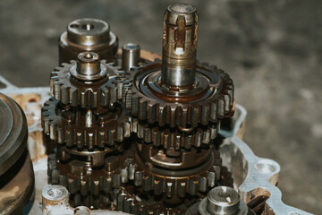 The mechanic is assembling the crankshaft and motorcycle gear.