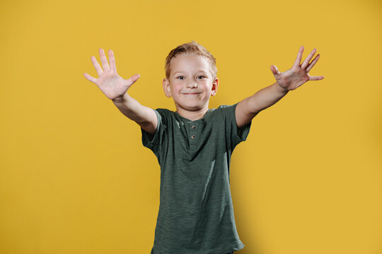 Portrait Of A Confident Smiling Ten Year Old Boy Standing In Front Of The Wall