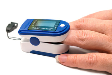 Determination of the level of oxygen in the blood during viral lung infection. Measurement of saturation with a portable pulse oximeter is isolated on a white background.