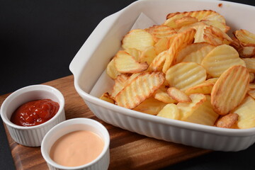 Homemade rippled potato chips and sauce, ketchup