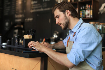 Small business owner working at his cafe.