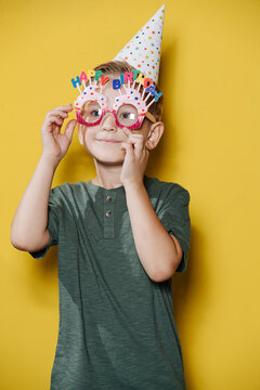 Cute Ten Year Old Birthday Boy Standing In Front Of The Wall