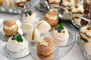 A table with desserts for guests at a wedding. Candy bar