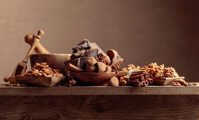 Various chocolates with ingredients on an old wooden table.