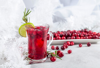 Christmas cranberry drink with berries, lime, and rosemary.