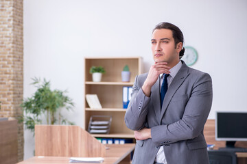 Young male employee working in the office