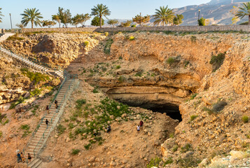 The top View of Bimmah Sinkhole, natural crater limestone blue lagoon from meteorite in Hawiyat Najm park, Muscat, Sultanate of Oman.