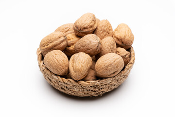 Walnuts in basket on white background