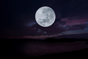 Obraz na płótnie Canvas Full moon over lake in the dark night.