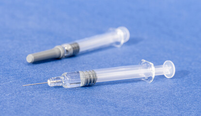 Vaccine - injection of a vaccine with a syringe - solution against the Covid-19 coronavirus - close-up of two syringes