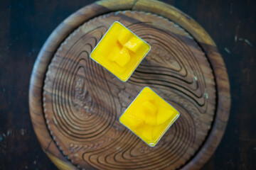 Mango Panna cotta with mango jelly, Italian dessert, homemade cuisine in a container.
