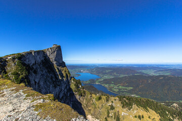 Fototapeta na wymiar View of lake Mondsee from top of Schafberg,Austria,Salzkammergut region.Blue sky, Alps mountains,Salzburg, nearby Wolfgangsee, Attersee.Hiking in Alps.Holiday freedom concept.Active lifestyle outdoors