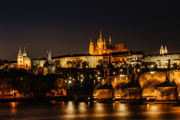 Fototapeta na wymiar Postcard view of night Prague panorama, capital of the Czech republic.Amazing European cityscape.Prague Castle,Charles Bridge,Vltava river at colorful sunset.Famous tourist destination.Night city.