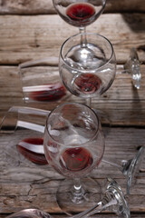 Glasses with the remains of red wine rustic wooden background. Copy of the space. Alcoholic drinks concept. View from above.