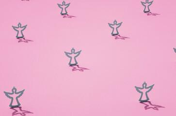 Grey contours of angels on pink surface