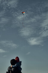 A man with a two-year-old child is flying a kite. Games with children, fatherhood.