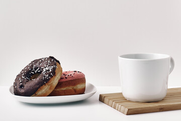 Mug and donuts cakes on a white background. Confectionery, coffee shop. Copy space, mock up