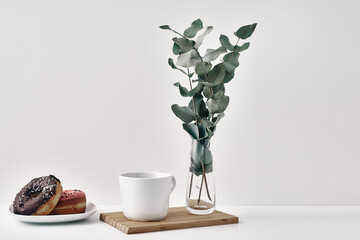 Mug and donuts cakes on a white background. Confectionery, coffee shop. Copy space, mock up