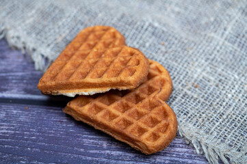 Delicious homemade cookies on the background of rough homespun fabric. Close-up, selective focus.