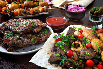 Skewered liver, whole vegetables and mushrooms on skewers. Grill restaurant menu. Georgian, Asian cuisine. Different dishes of liver kebab.