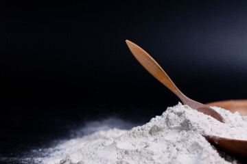 In the lower-right corner of the screen, there is a Cup, a wooden spoon, and a pile of white flour. Side view.