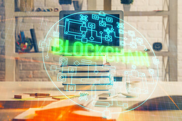 Multi exposure of blockchain and crypto economy theme hologram and table with computer background....