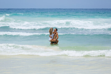 Beautiful lover couple enjoy their honeymoon in tropical waters of the Indian Ocean, Seychelles.